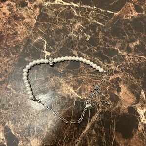 Faux pearl anklet with silver tone skull accent bead featuring rhinestone accent